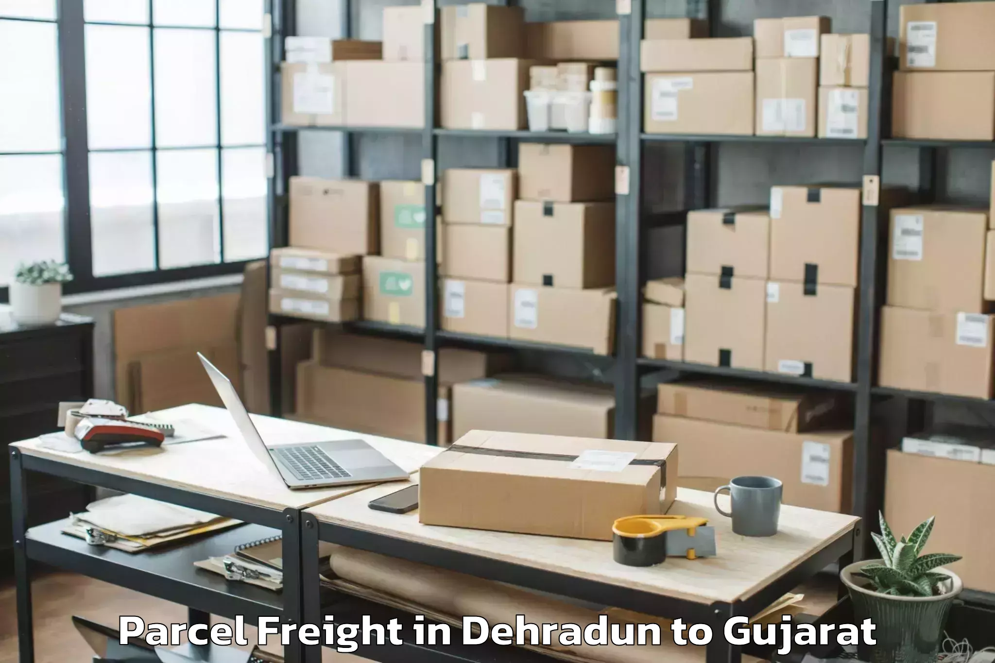 Book Dehradun to Bhanvad Parcel Freight Online